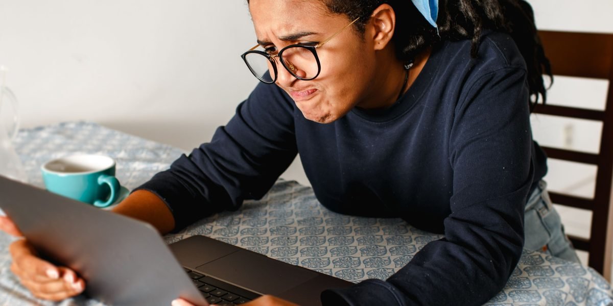 A person looking frustrated while browsing streaming options, unable to find something engaging to watch.