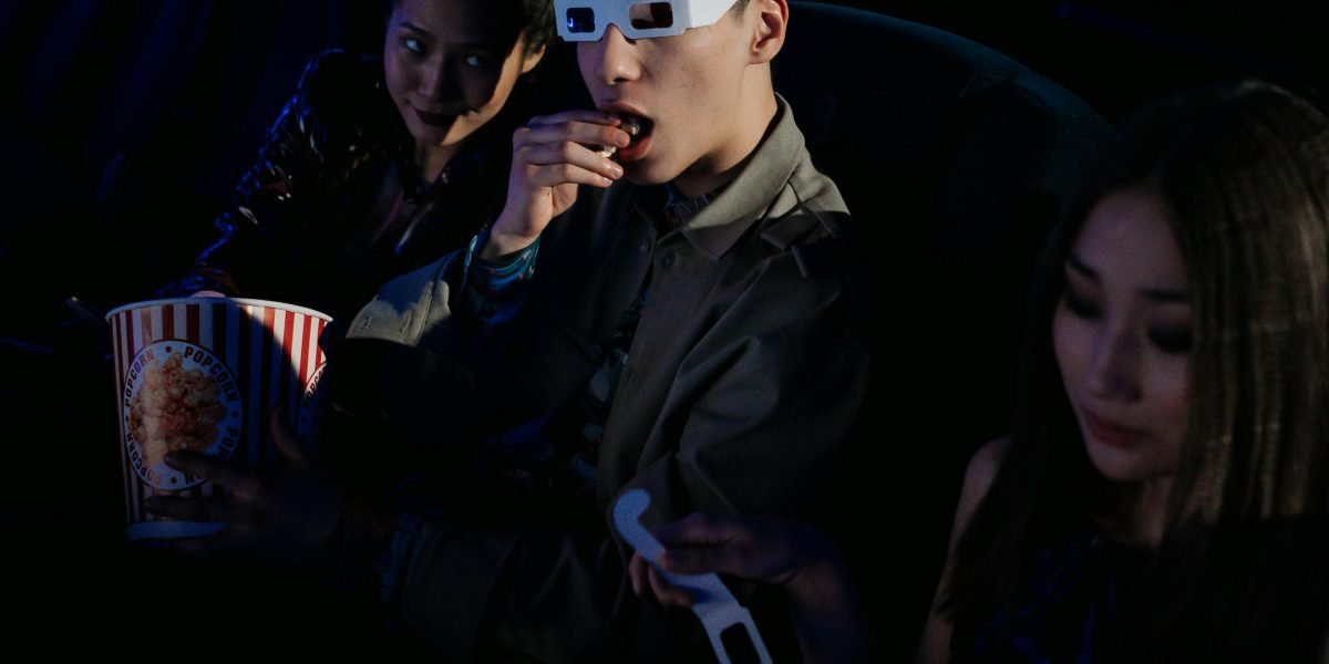 Friends or a family excitedly watching a movie together, sharing a memorable experience.