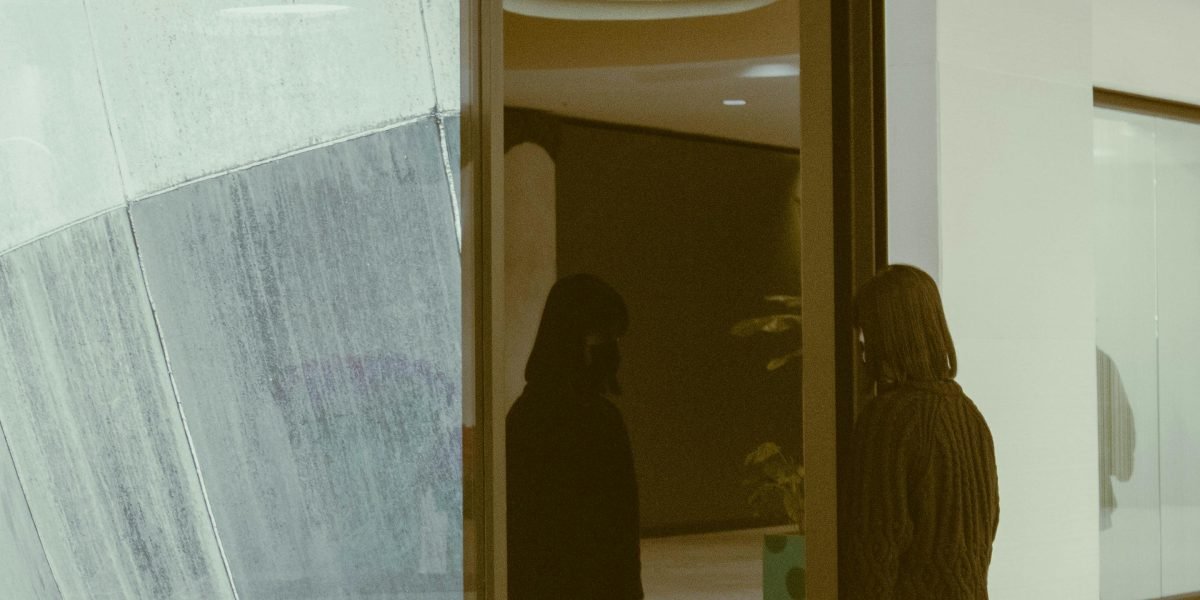 A person in a stark, minimalist environment, conveying a sense of isolation and control as depicted in dystopian films.