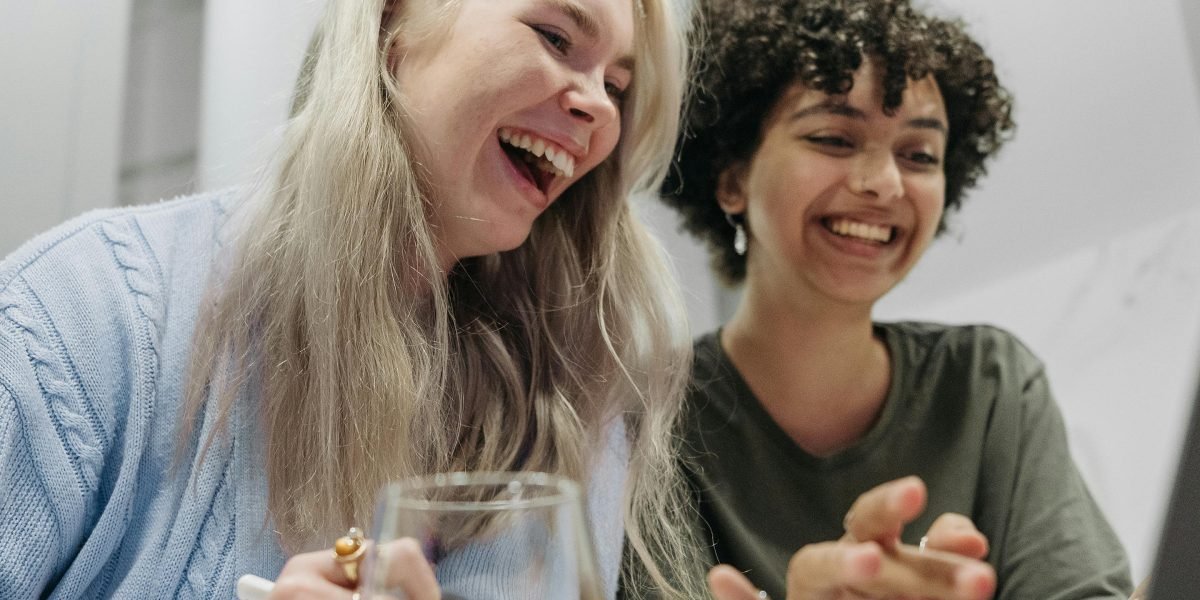 A person genuinely enjoying a moment of laughter, reflecting the humor of sci-fi comedy.