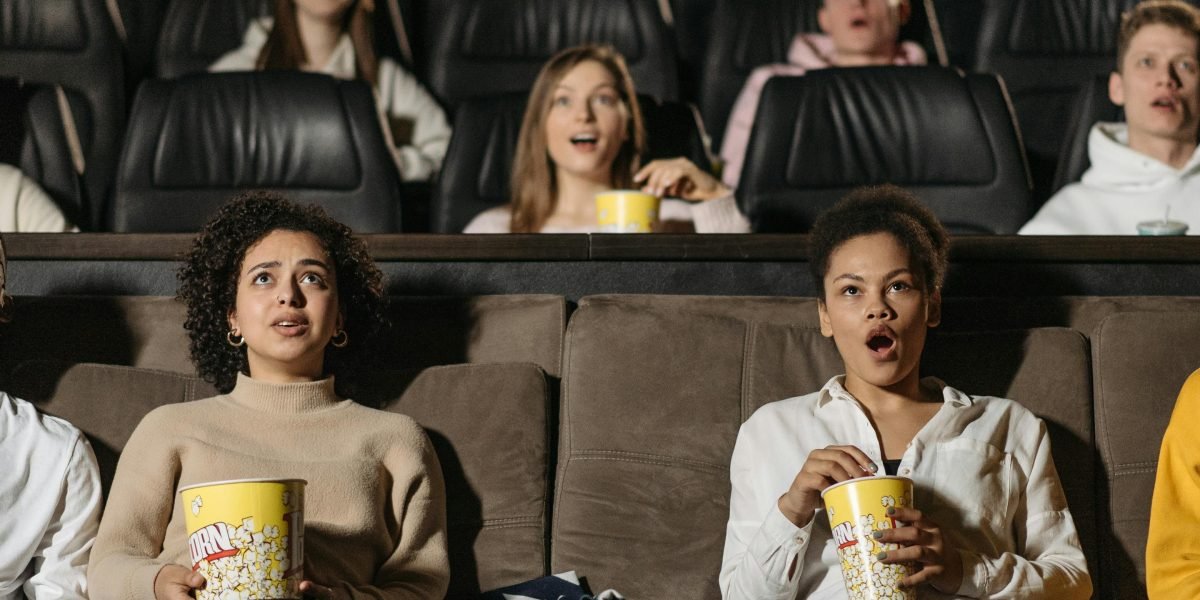 Capturing the intense emotions of an audience deeply immersed in a thrilling horror film.