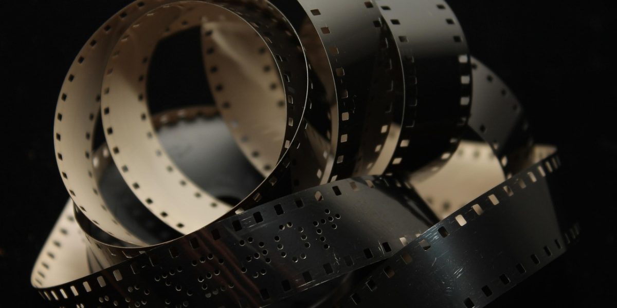 A viewer thoughtfully observing a film, appreciating the intricate technical and artistic elements.