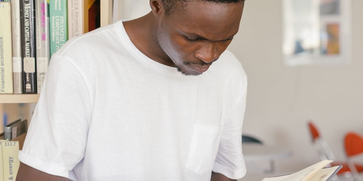 A person is deeply engrossed in research, looking for specific information or hidden details.