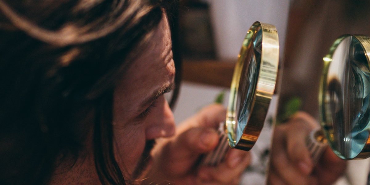 A person carefully examining historical or cultural artifacts, symbolizing the preservation of rare films.