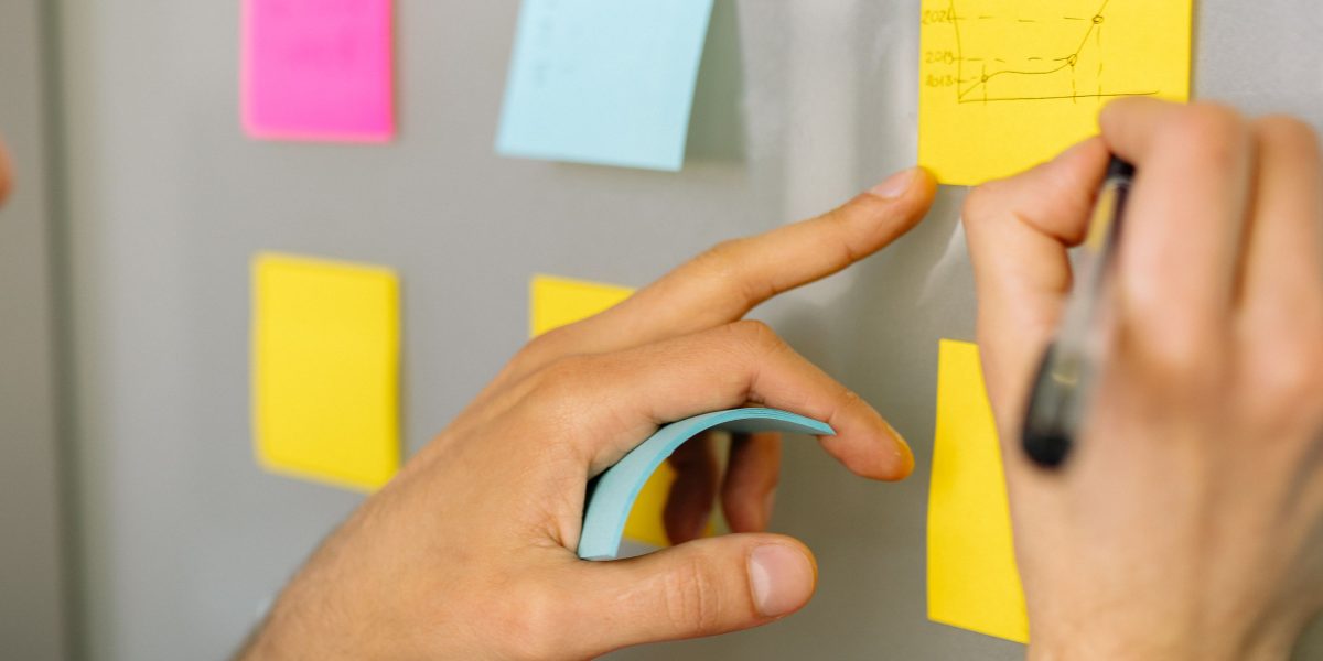 A person thoughtfully organizing information or creating a plan, symbolizing the workflow for film discovery.